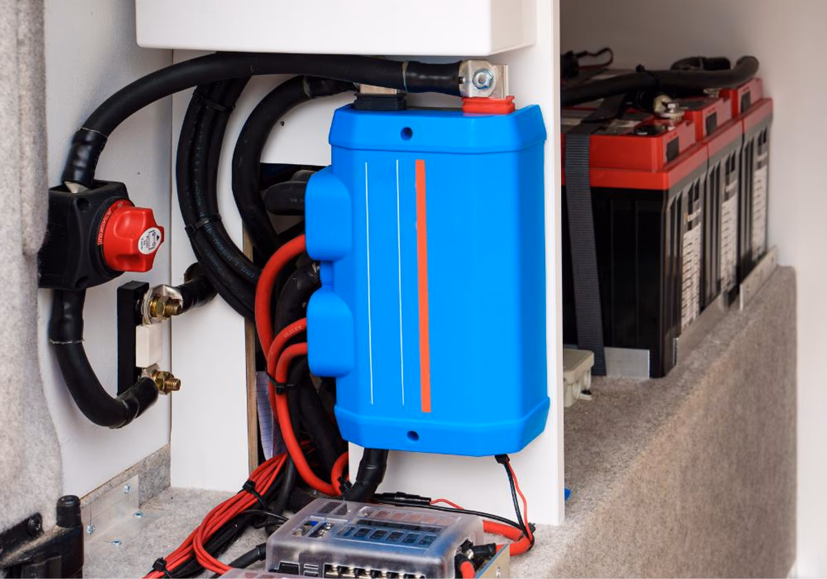 A photo of the the DC to DC charger installation on a bus bar on a Ram Promaster