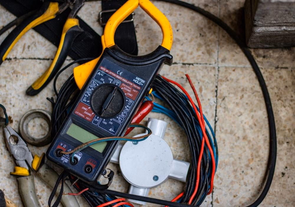Essential electrical tools laid out for a DIY van conversion electrical system installation