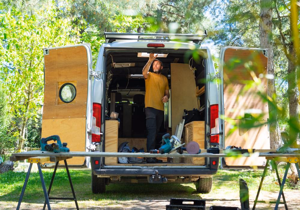 A DIY van builder working in their van